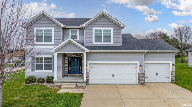 view of front of house featuring a front yard and a garage