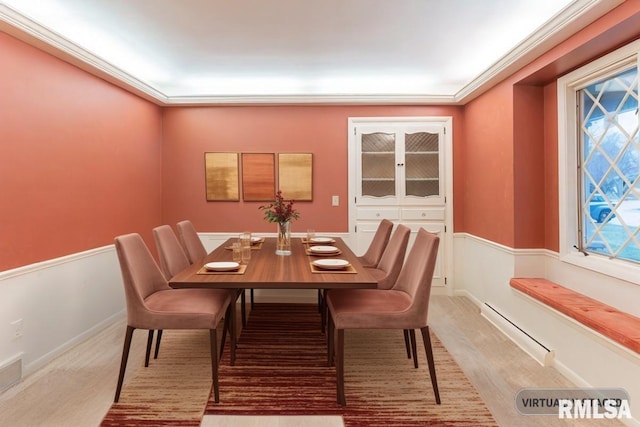 carpeted dining space featuring ornamental molding