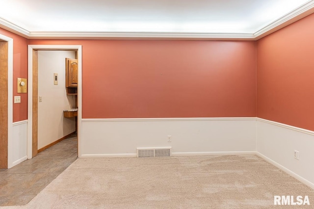 empty room with light colored carpet and ornamental molding