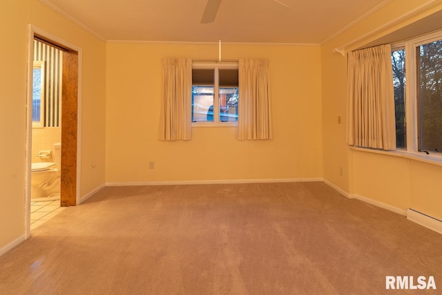 unfurnished room with ceiling fan, baseboard heating, ornamental molding, and carpet flooring