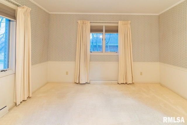 unfurnished room with baseboard heating, carpet flooring, and crown molding