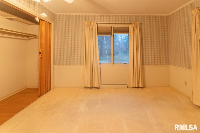 unfurnished bedroom featuring a closet, crown molding, and hardwood / wood-style flooring