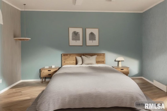 bedroom featuring crown molding and hardwood / wood-style floors