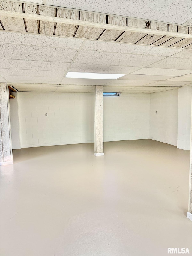 basement featuring a paneled ceiling