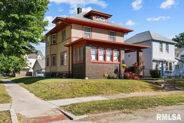 view of front of property featuring central AC and a front yard