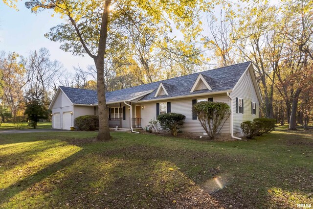 single story home featuring covered porch, a garage, and a front yard