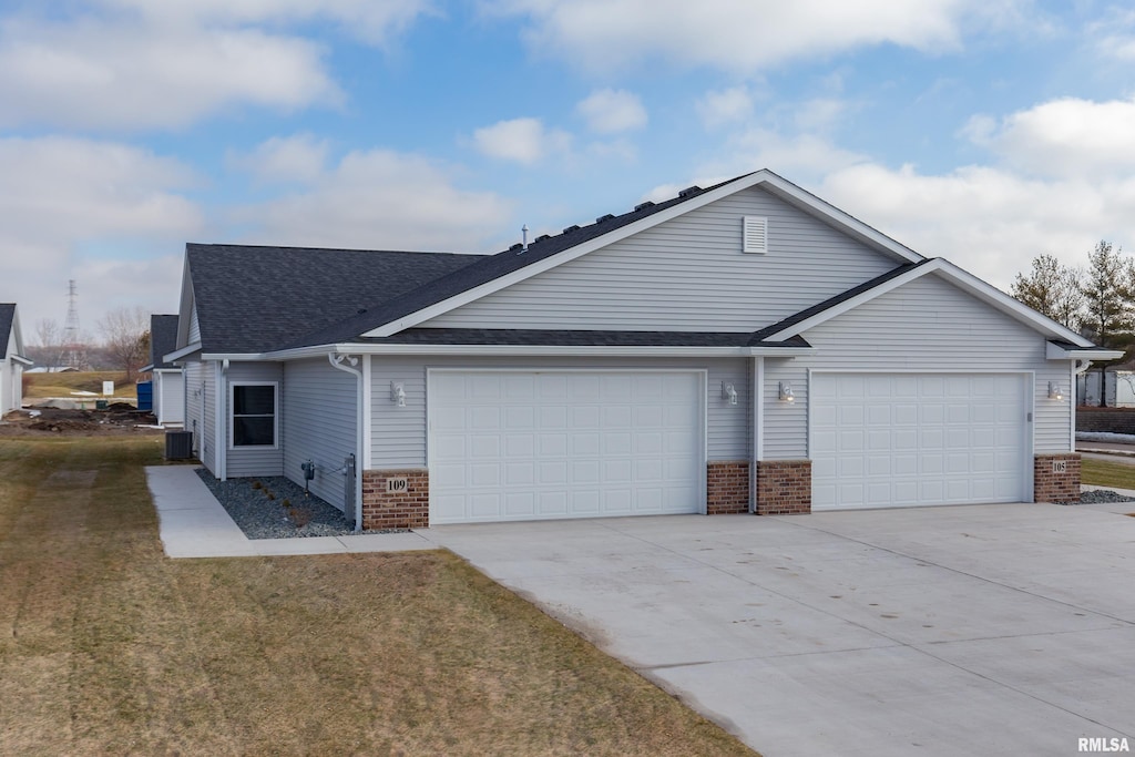 ranch-style house with central air condition unit, a front yard, and a garage