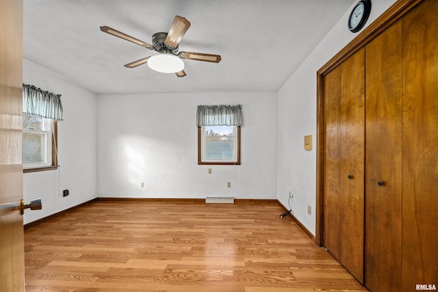 unfurnished bedroom with a closet, light hardwood / wood-style floors, and ceiling fan