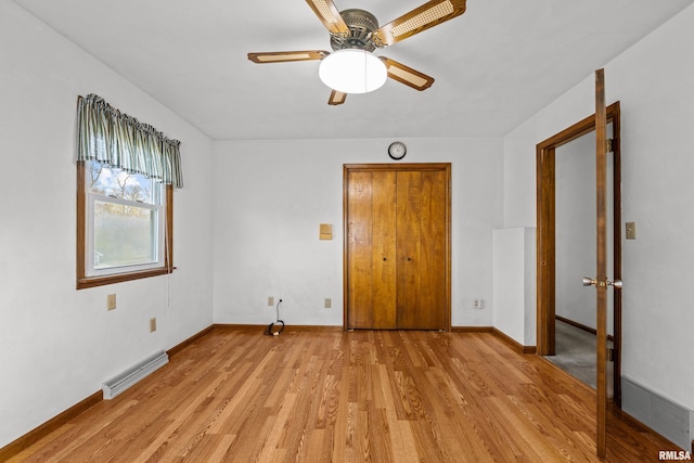 empty room featuring ceiling fan and light hardwood / wood-style floors