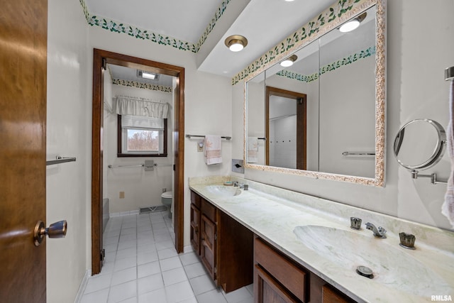 bathroom featuring tile patterned floors, vanity, and toilet