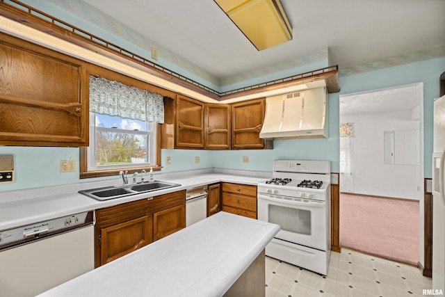 kitchen featuring white appliances, sink, and range hood