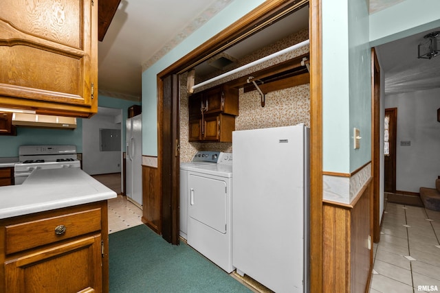 kitchen with exhaust hood, white appliances, and washing machine and clothes dryer