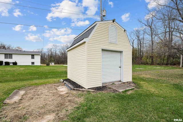 view of outbuilding with a yard