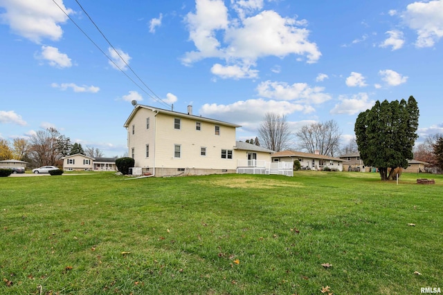 rear view of property with a lawn