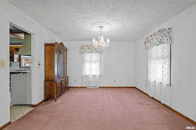 unfurnished room with a chandelier, a textured ceiling, and light colored carpet