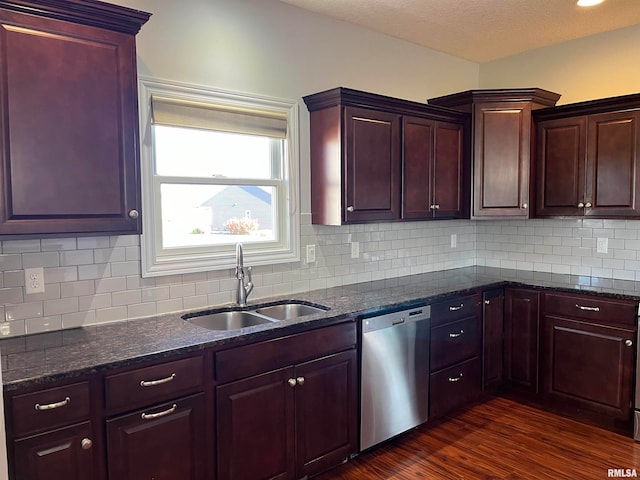 kitchen with dishwasher, decorative backsplash, dark stone counters, and sink