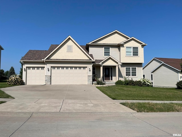 view of front of house with a front yard and a garage