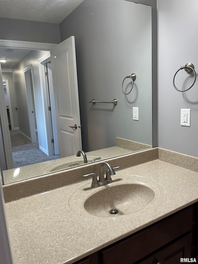 bathroom featuring vanity and a textured ceiling