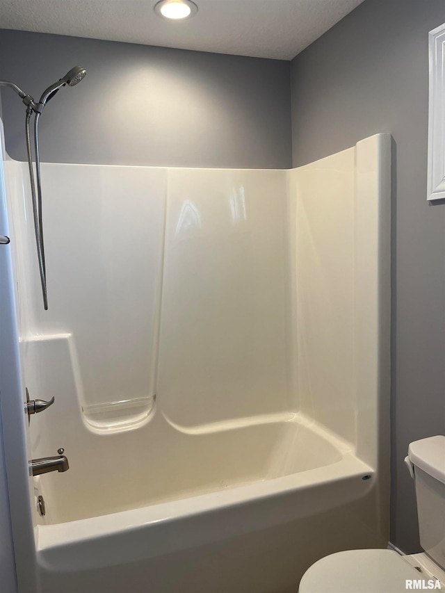 bathroom with shower / bathing tub combination and toilet