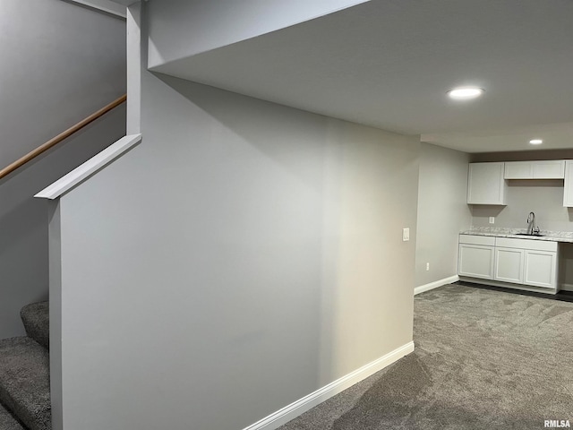 interior space with carpet flooring and sink