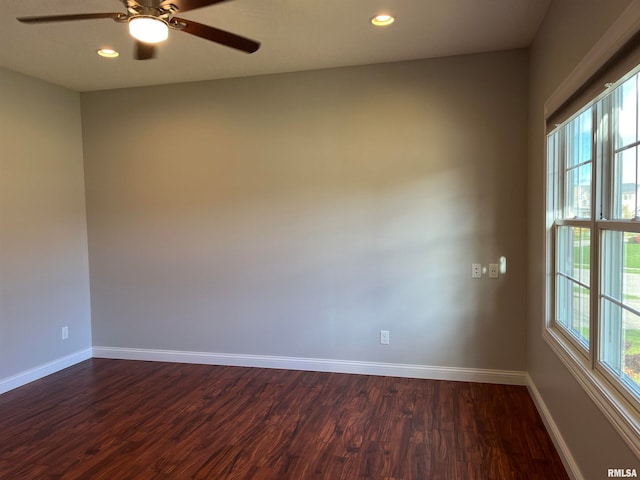 empty room with ceiling fan and dark wood-type flooring