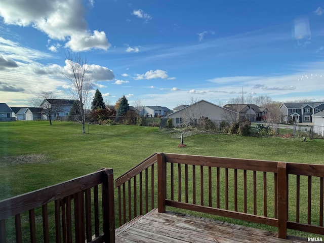 wooden terrace featuring a lawn