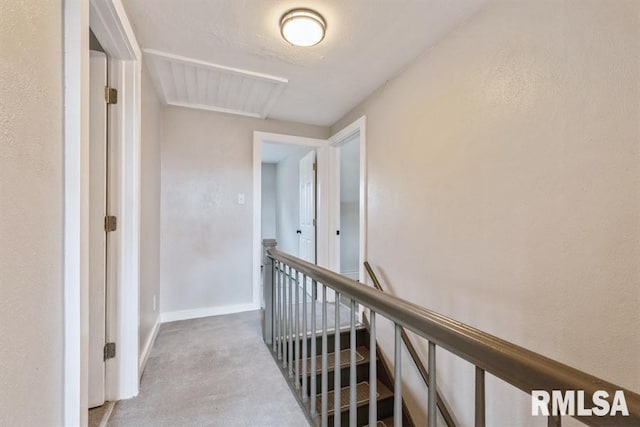 hallway featuring light colored carpet