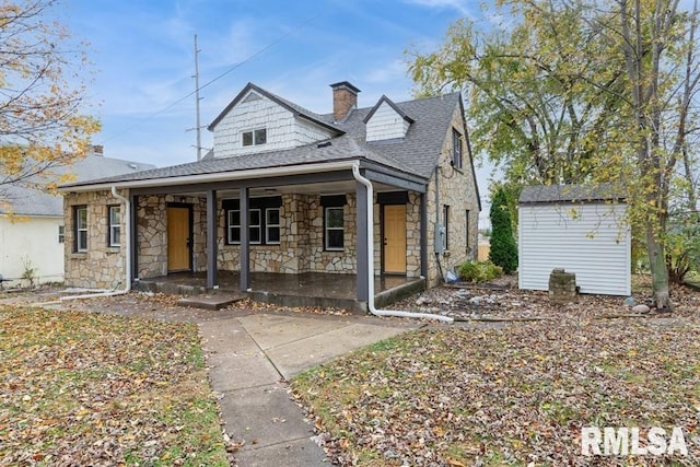 view of front of home featuring covered porch and a storage unit