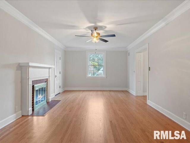 unfurnished living room with crown molding, a fireplace, ceiling fan, and light hardwood / wood-style flooring