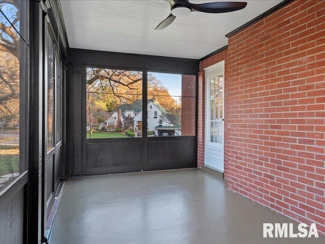 unfurnished sunroom with a ceiling fan