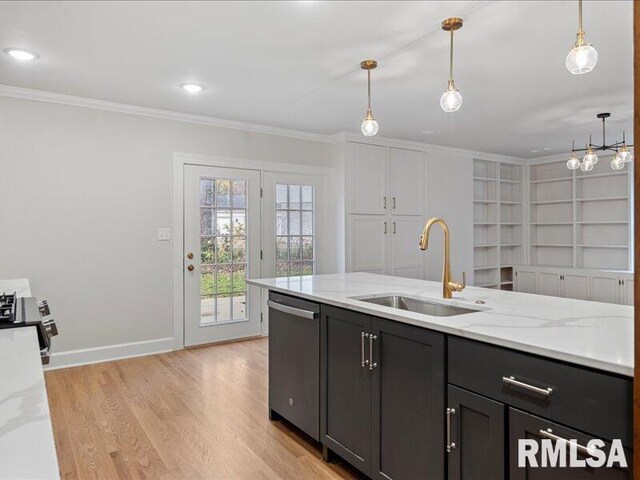 kitchen featuring stainless steel appliances, a sink, hanging light fixtures, light stone countertops, and crown molding