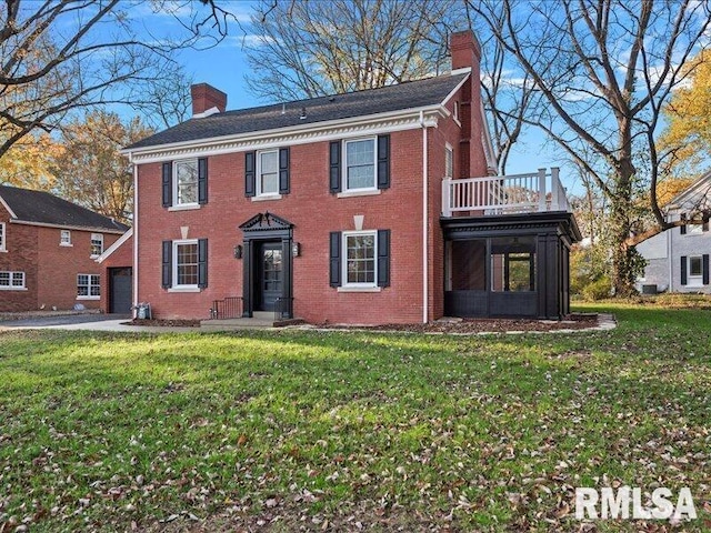 view of front of home with a front yard and a balcony