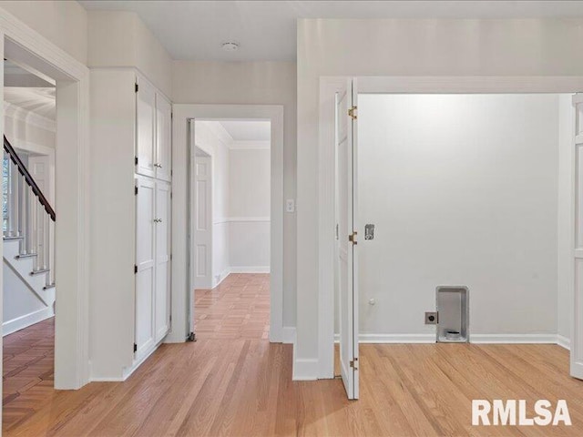 hall featuring ornamental molding and light wood-type flooring