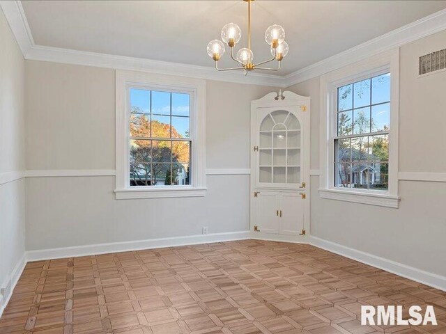 unfurnished dining area featuring crown molding and a notable chandelier