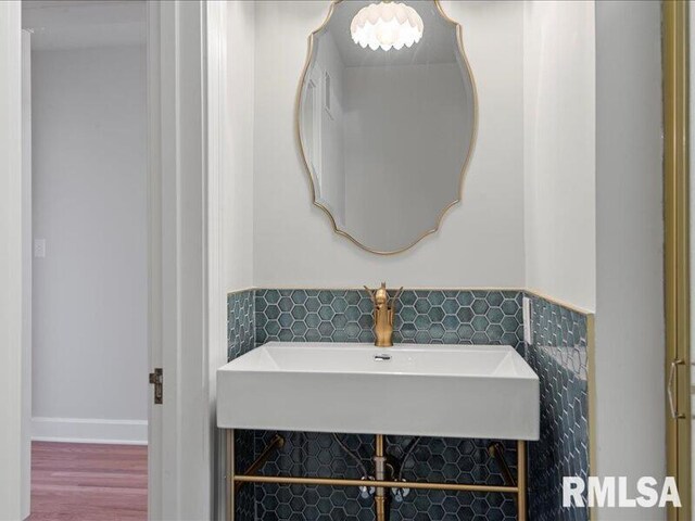 bathroom with tile walls and a sink