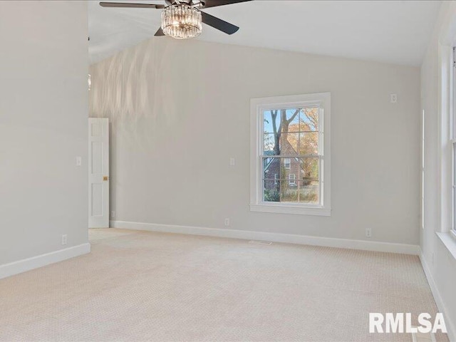 carpeted spare room with ceiling fan and lofted ceiling