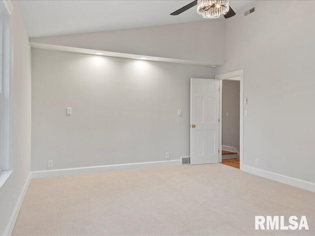 unfurnished room with light colored carpet, ceiling fan, and lofted ceiling