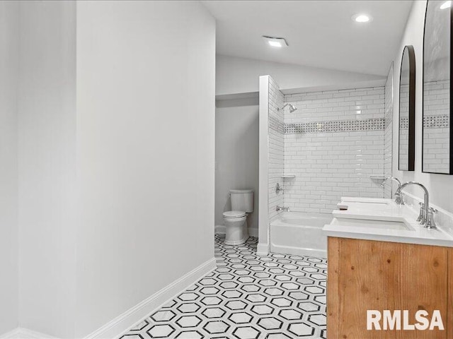 full bathroom featuring tile patterned floors, vanity, vaulted ceiling, toilet, and tiled shower / bath