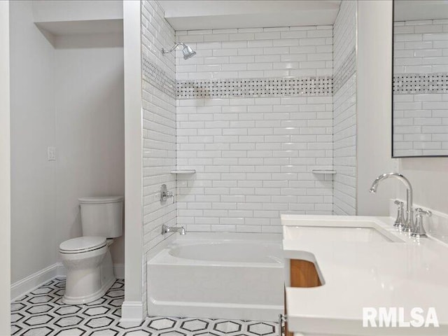 full bathroom with  shower combination, baseboards, a sink, and toilet