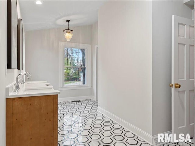 bathroom featuring a chandelier and vanity