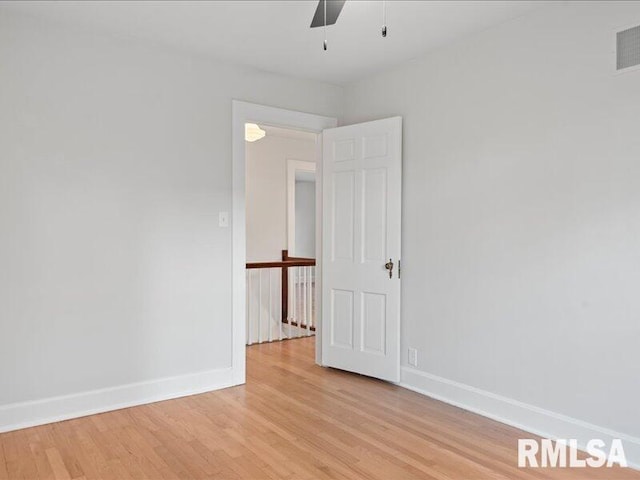 spare room featuring ceiling fan and light hardwood / wood-style flooring