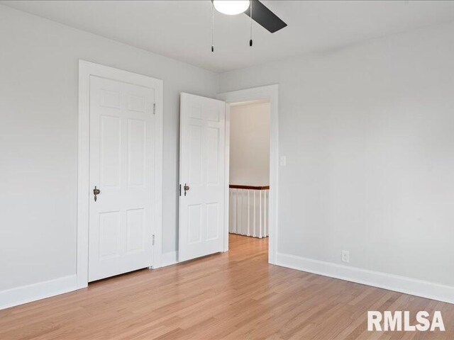 unfurnished bedroom with ceiling fan and light hardwood / wood-style floors