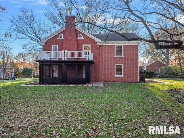 rear view of house featuring a lawn, central air condition unit, and a deck