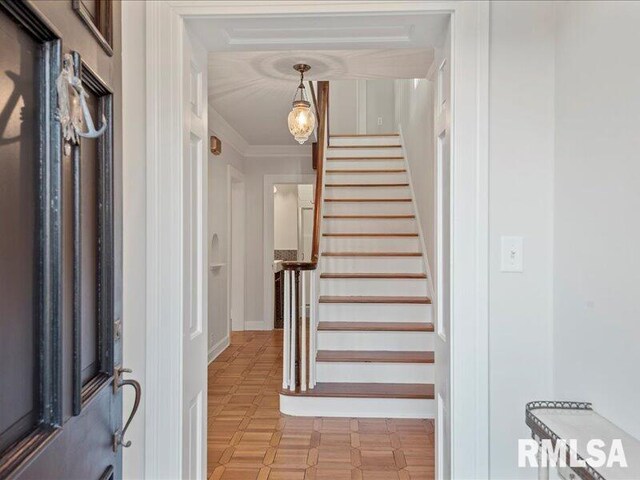 foyer with stairway and ornamental molding