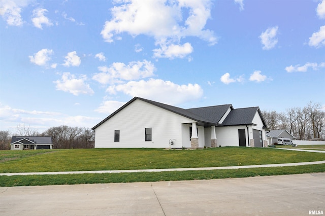 view of home's exterior with a lawn and a garage