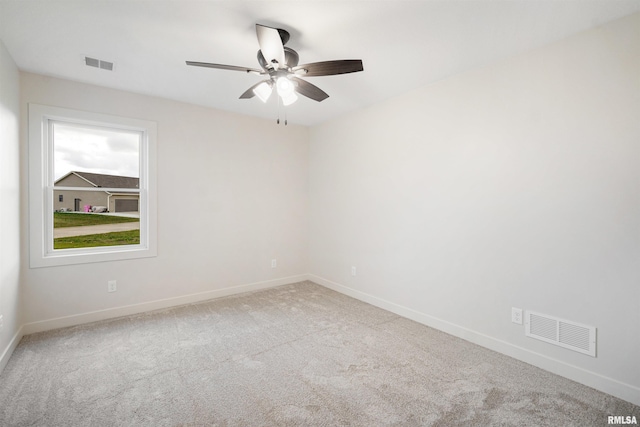 carpeted empty room featuring ceiling fan