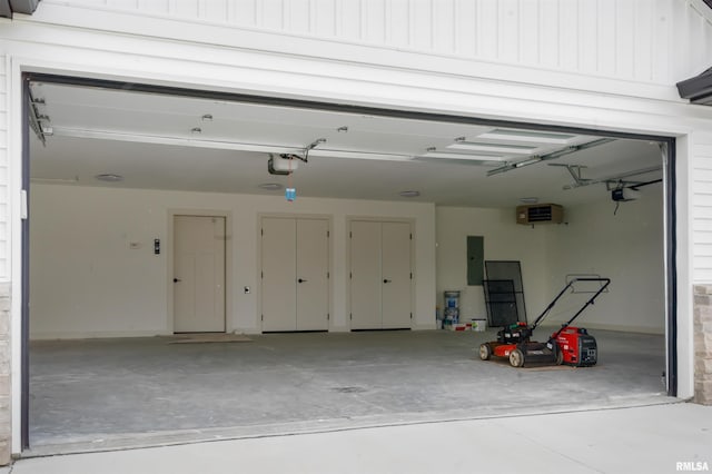 garage with electric panel and a garage door opener