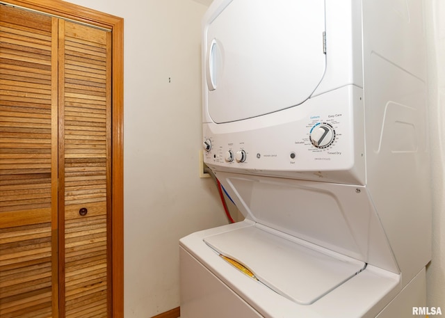 washroom featuring stacked washer / drying machine