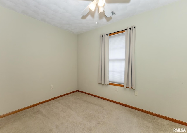 unfurnished room featuring ceiling fan and light colored carpet