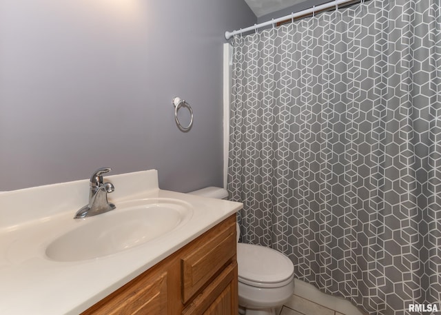 bathroom with tile patterned flooring, vanity, and toilet